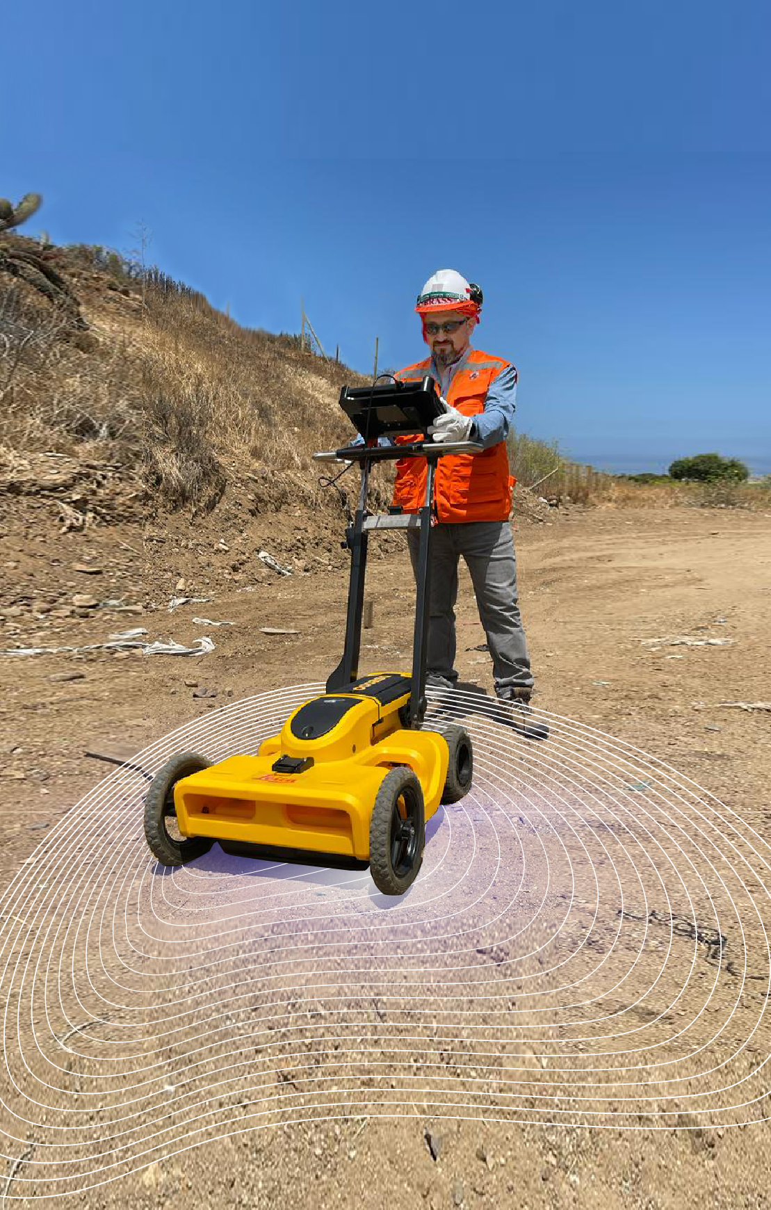 Técnico experto con equipo georadar en un terreno similar a la ladera con caminos de una cerro